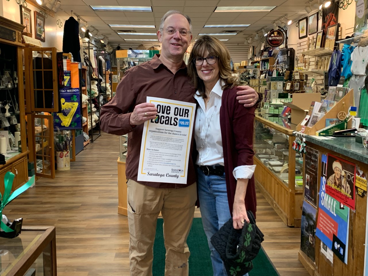 Community Business owners holding Love Our Locals $20.22 posters