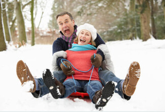 mature couple sledding