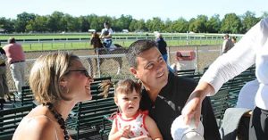 Couple with young child having breakfast trackside