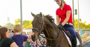 boy petting race horse